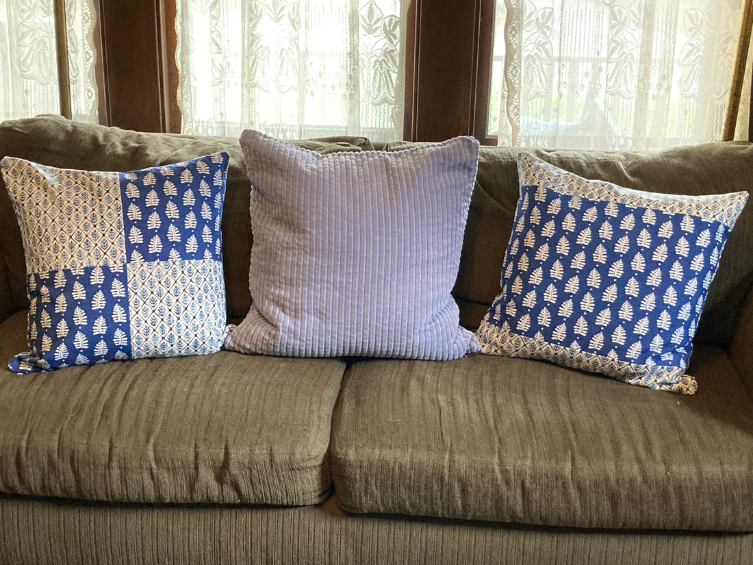 Green sofa with blue pillows