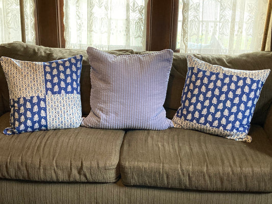 Green sofa with blue pillows
