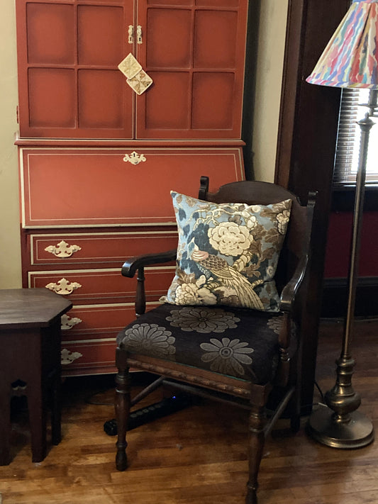 1950s red secretary desk, armchair with chinoisirie pillow, hexagonal end table, and brass lamp